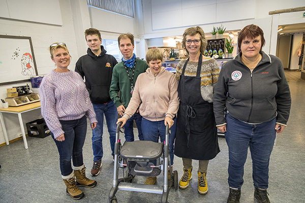 6 personer står inne. De står på rekke og alle ser mot kameraet og smiler